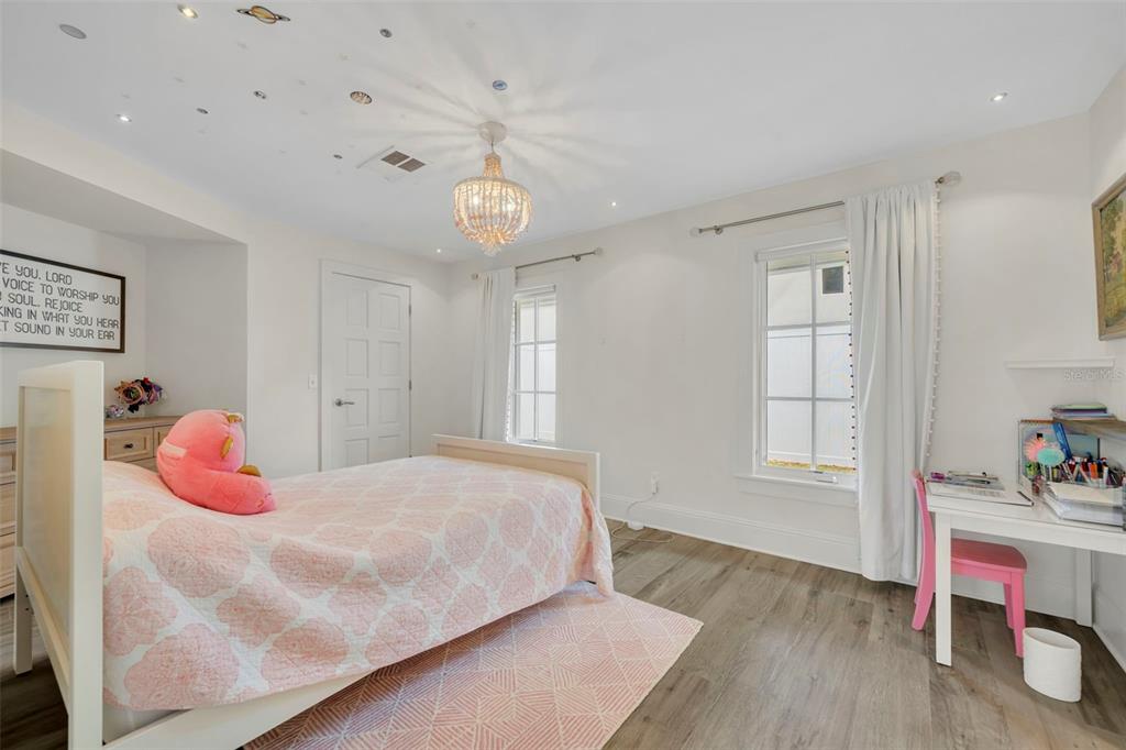 700 Pinetree Road Winter Park, FL 32789 - Photo 39 of 58 a bedroom with a bed and wooden floor