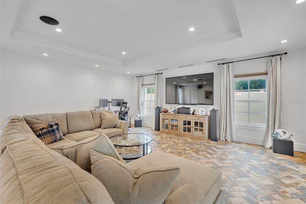 700 Pinetree Road Winter Park, FL 32789 - Photo 42 of 58 a living room with furniture and a flat screen tv