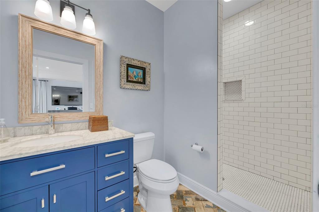 700 Pinetree Road Winter Park, FL 32789 - Photo 46 of 58 a bathroom with a granite countertop toilet sink and mirror