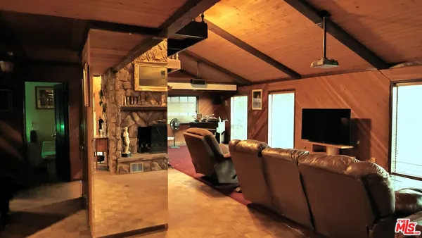 a view of a livingroom with furniture and a flat screen tv