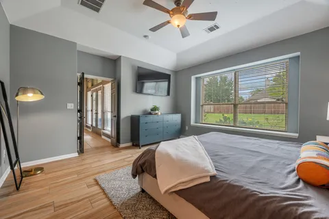 a spacious bedroom with a bed and a large window