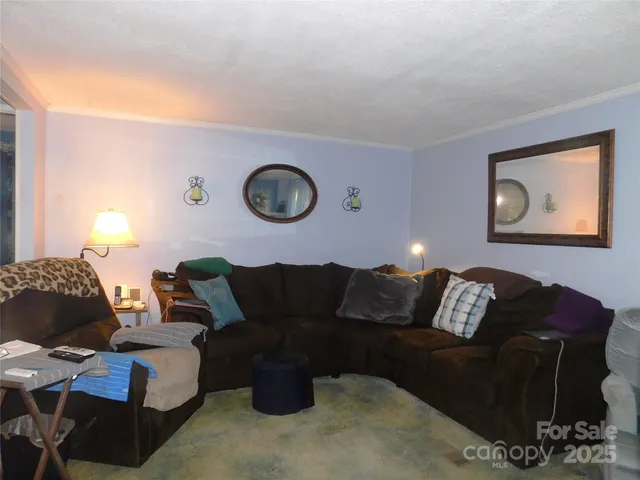 a large bed sitting in a bedroom next to a window