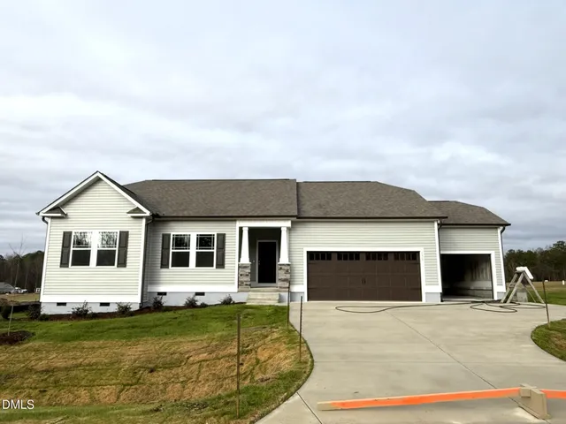 a backyard of a house with table and sofas