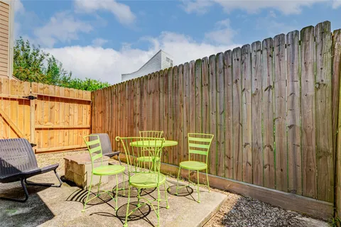 a backyard of a house with outdoor seating