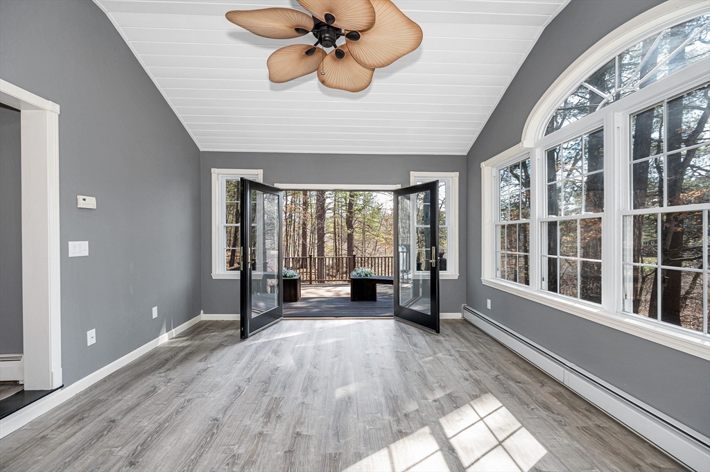 a view of a room with wooden floor and furniture