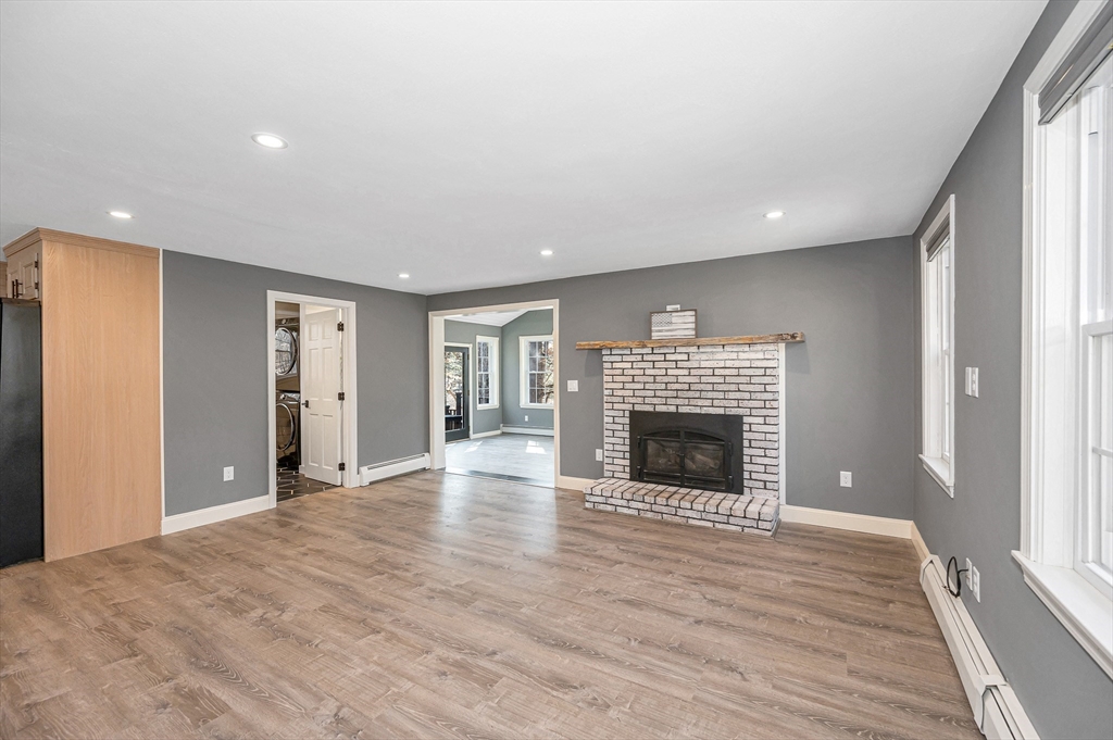 17 Autumn Street Windham, NH 03087 - Photo 12 of 42 a view of an empty room with wooden floor fireplace and a window