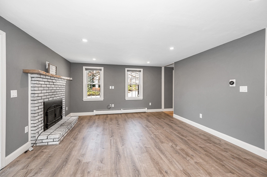 17 Autumn Street Windham, NH 03087 - Photo 14 of 42 a view of an empty room with wooden floor and a window