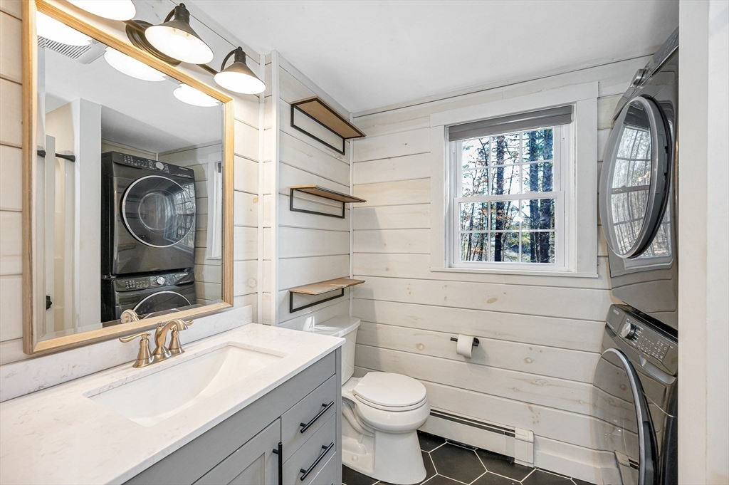 17 Autumn Street Windham, NH 03087 - Photo 16 of 42 a bathroom with a toilet sink and mirror