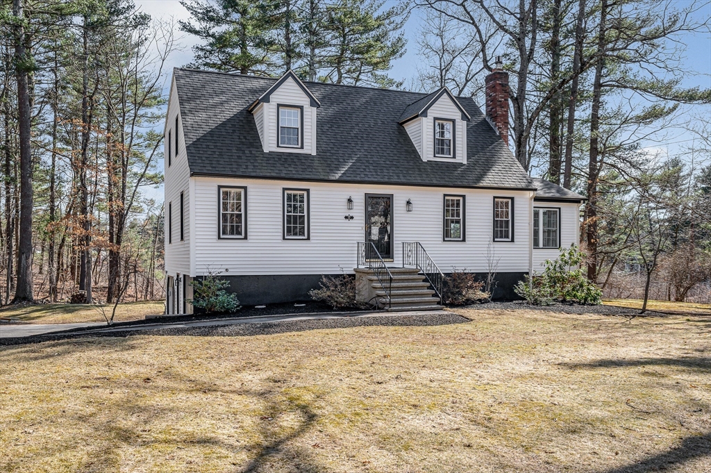 17 Autumn Street Windham, NH 03087 - Photo 2 of 42 a view of a white house with large windows next to a road