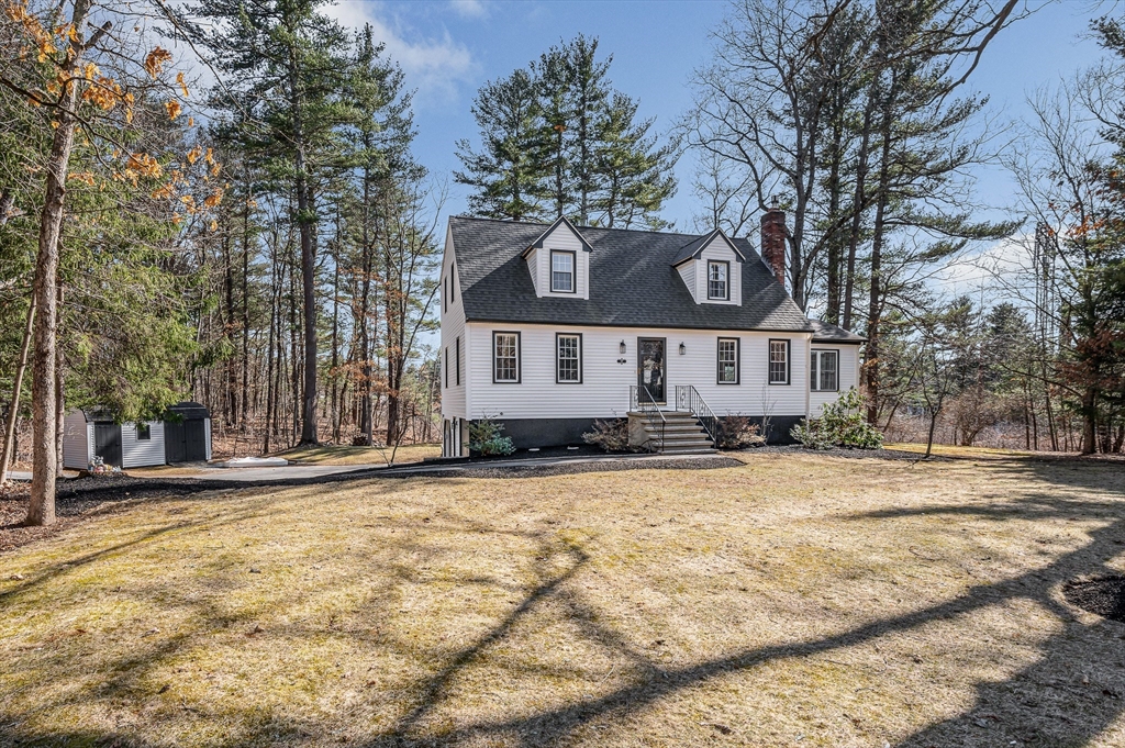 17 Autumn Street Windham, NH 03087 - Photo 40 of 42 a front view of a house with a yard and trees