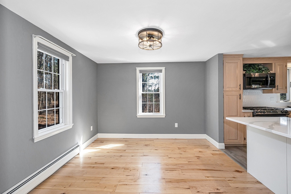 17 Autumn Street Windham, NH 03087 - Photo 4 of 42 a view of an empty room with a window and wooden floor