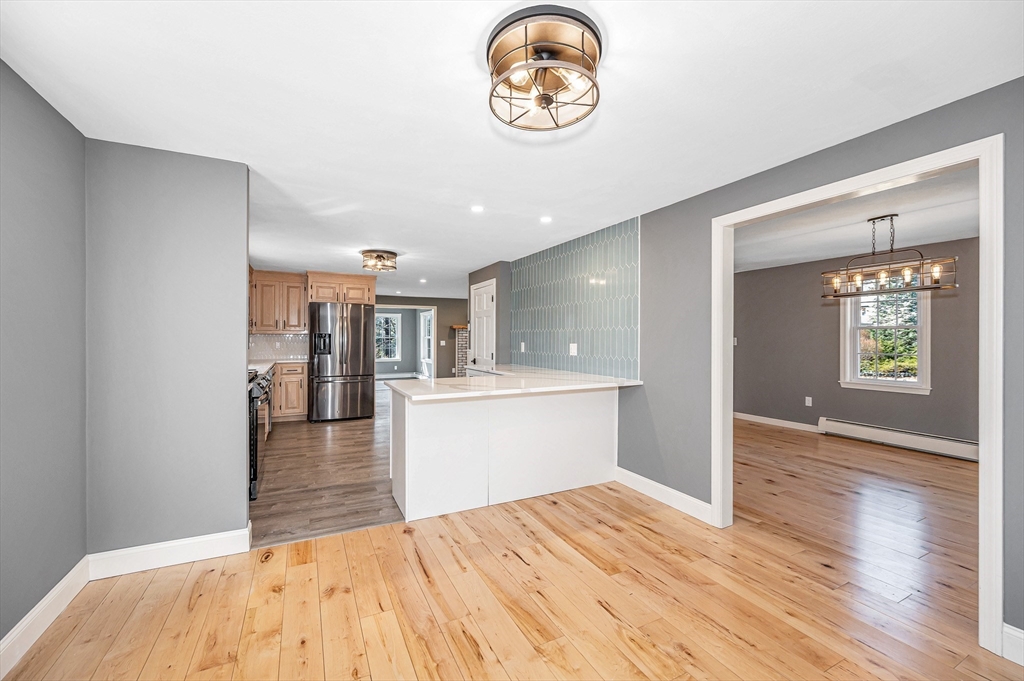 17 Autumn Street Windham, NH 03087 - Photo 6 of 42 a view interior of kitchen and hall with wooden floor