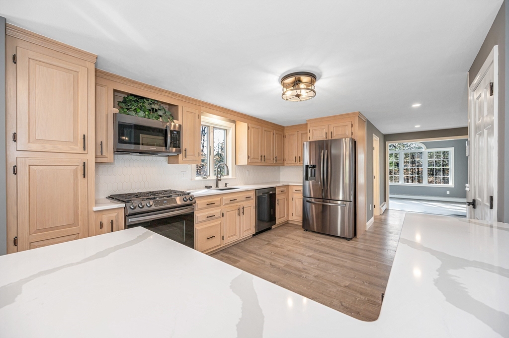 17 Autumn Street Windham, NH 03087 - Photo 9 of 42 a kitchen with a stove a refrigerator and a sink