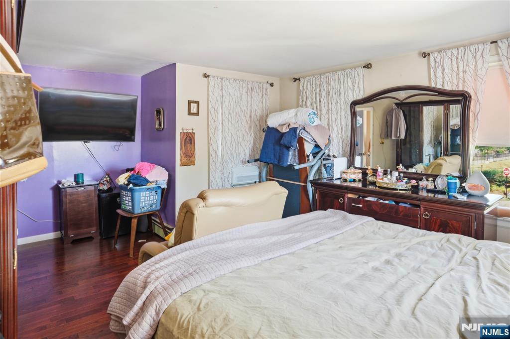 33-35 Pulaski Place Hackensack, NJ 07601 - Photo 17 of 32 a bedroom with a bed and a chandelier