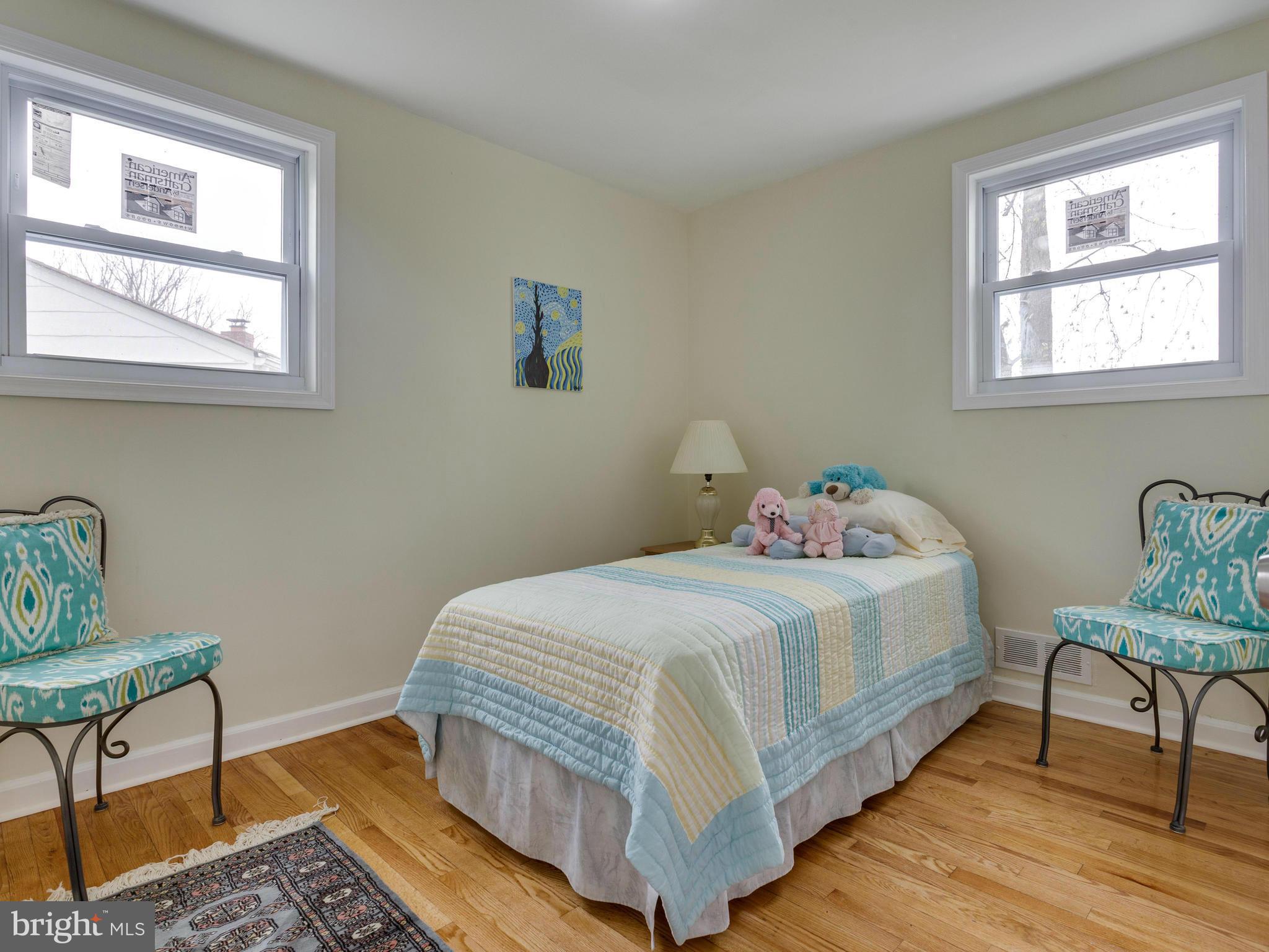 4002 Gannon Road Silver Spring, MD 20902 - Photo 14 of 30 a bedroom with a bed and wooden floor