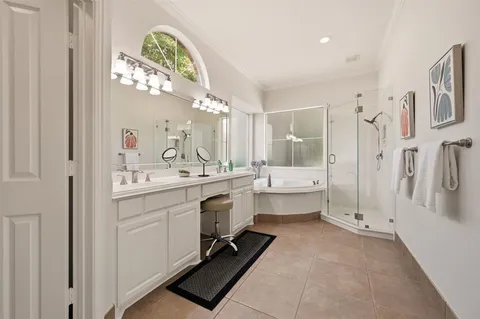 a bathroom with a double vanity sink mirror and shower