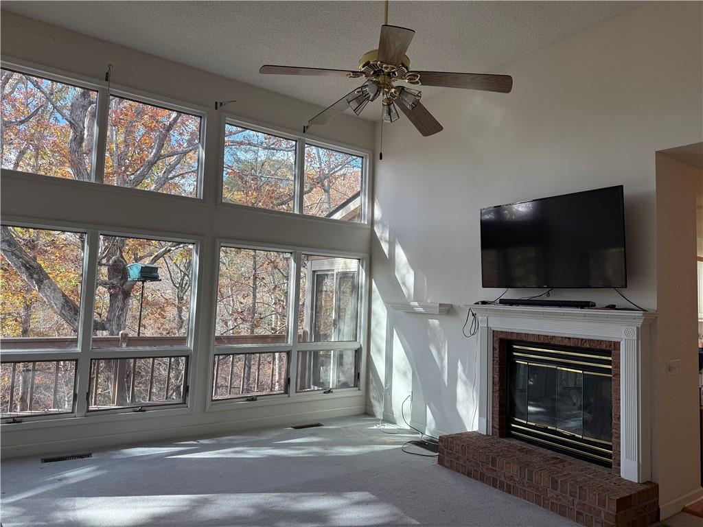 76 Remington Lane Jasper, GA 30143 - Photo 3 of 19 a living room with a fireplace a flat screen tv and a fireplace