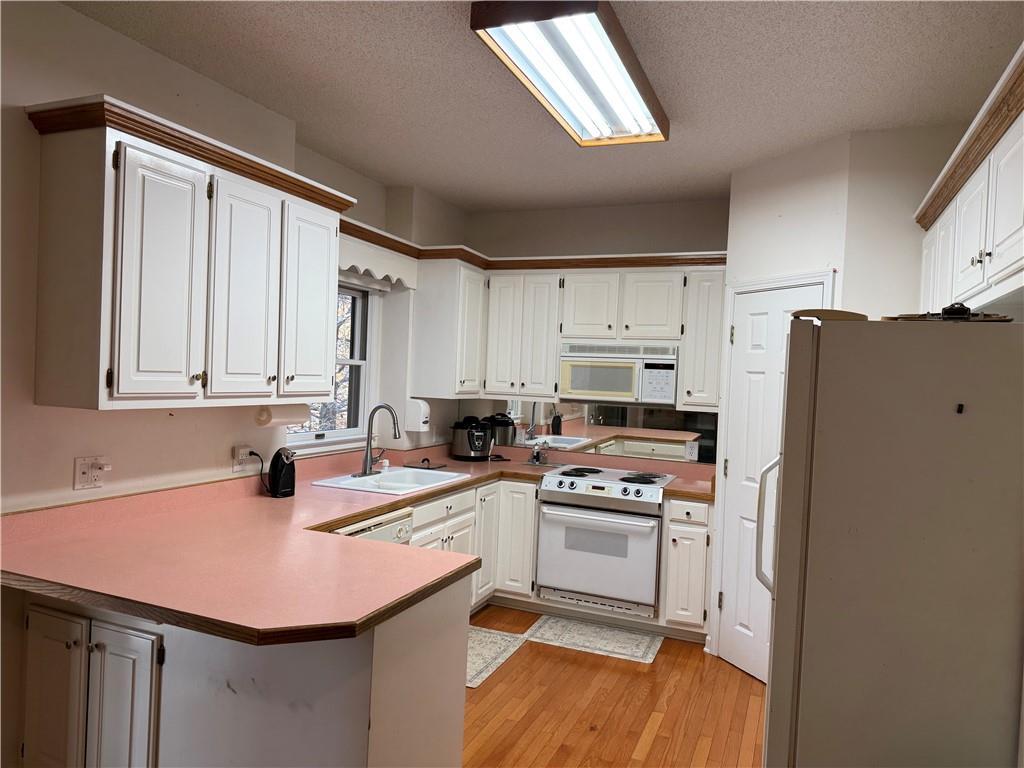 76 Remington Lane Jasper, GA 30143 - Photo 8 of 19 a kitchen with a sink a refrigerator and cabinets