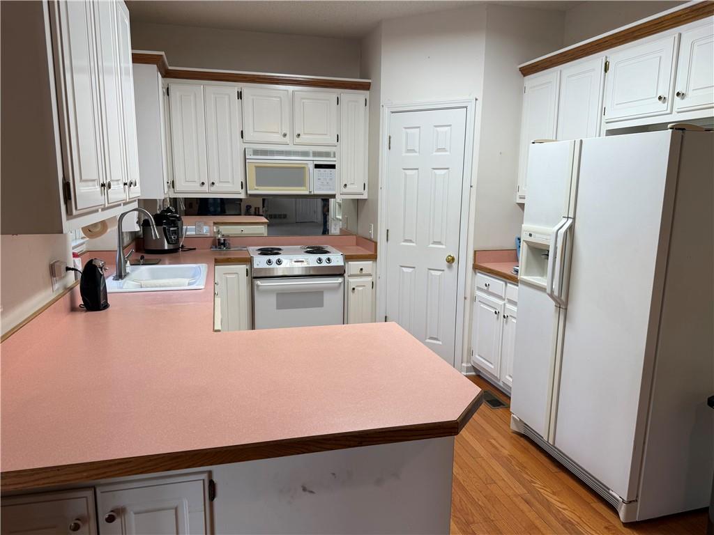 76 Remington Lane Jasper, GA 30143 - Photo 9 of 19 a kitchen with stainless steel appliances a refrigerator sink and cabinets