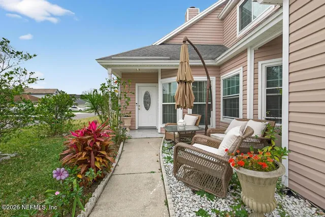 a front view of a house with outdoor seating