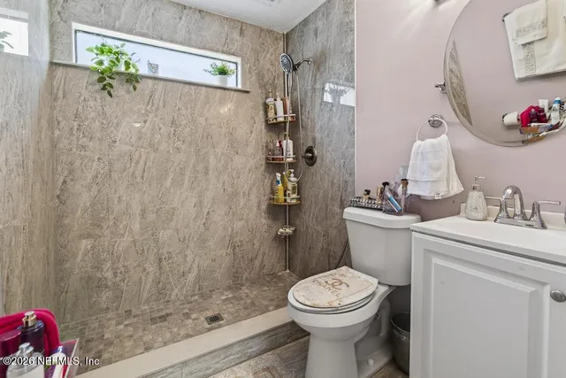a white toilet sitting next to a bathroom sink