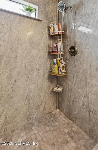 a large bed sitting in a bedroom next to a window