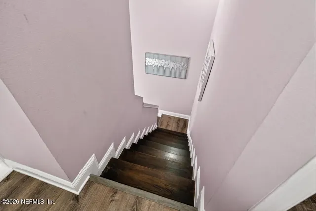 a view of walk in closet with wooden floor