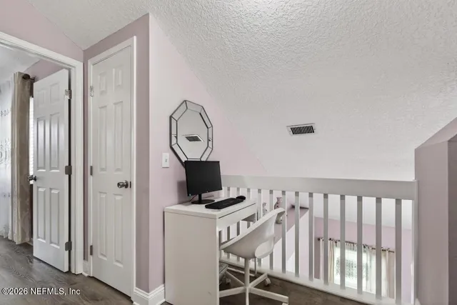 a kitchen with a refrigerator and a stove top oven