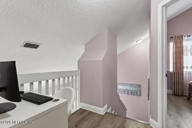 a dining room with couches and chandelier