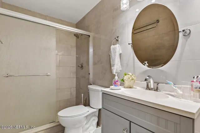 a bathroom with a sink mirror toilet and vanity