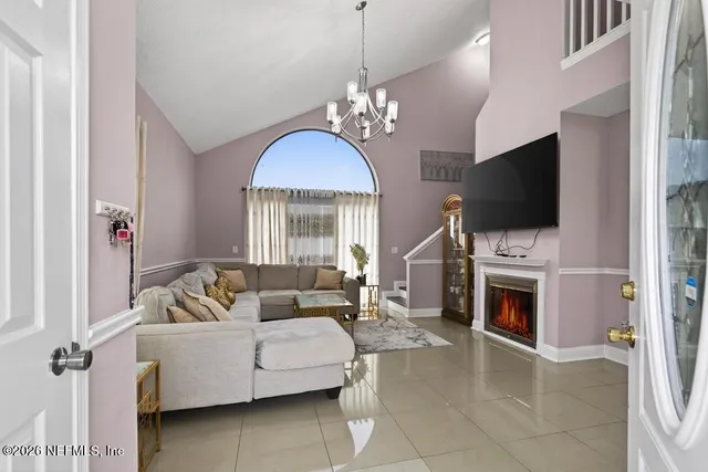 a living room with furniture a fireplace and a flat screen tv