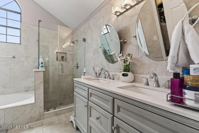 a bathroom with a sink vanity and a mirror