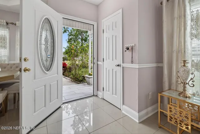 a living room with furniture a fireplace and a chandelier