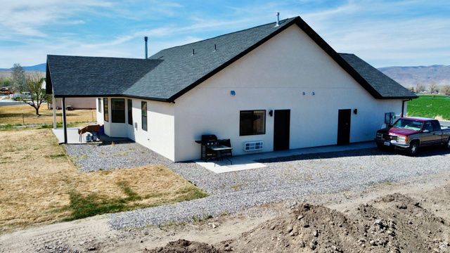277 West 800 South Monroe, UT 84754 - Photo 42 of 46 View of side of property with a mountain view, a shingled roof, a patio, and stucco siding