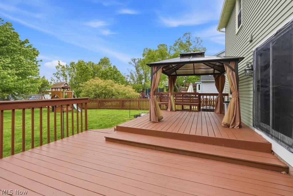 5321 Young Road Stow, OH 44224 - Photo 3 of 37 Expansive backyard deck featuring a gazebo, brown wood railing, and direct access to the lawn