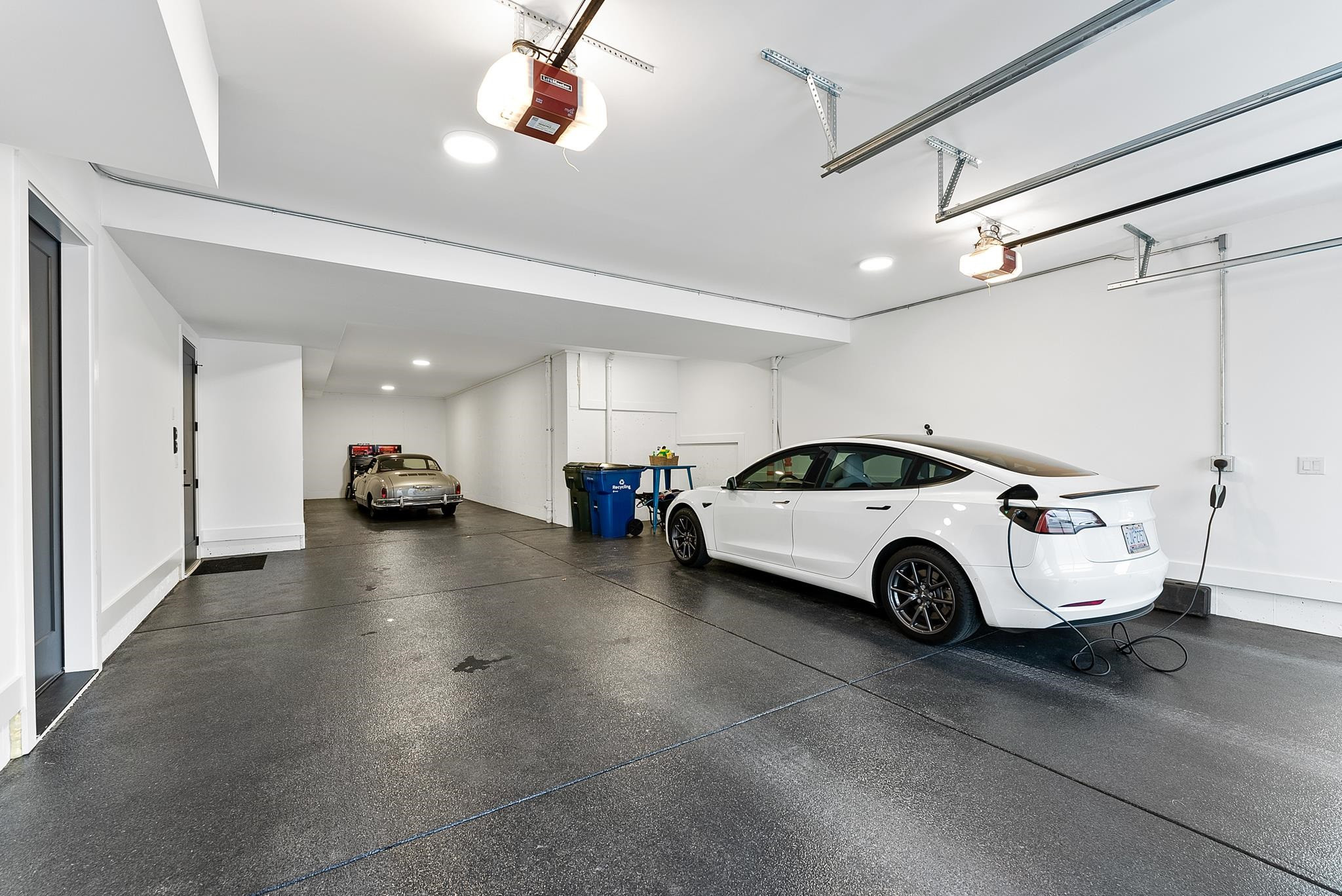 2511 Stafford Avenue Raleigh, NC 27607 - Photo 65 of 74 2 electric charging ports, glass/steel garage doors, epoxy floor, and two ample storage rooms. Rare! Room for 5 Cars!