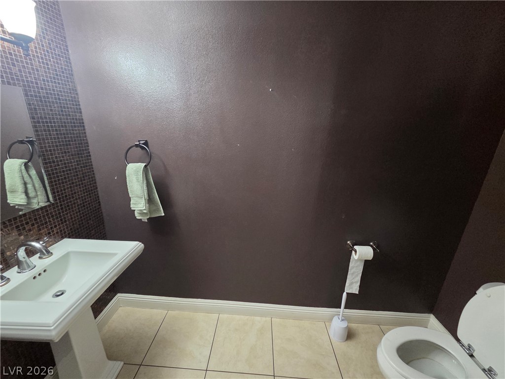 3381 Westwind Road Las Vegas, NV 89146 - Photo 21 of 52 A well-appointed lavatory with pedestal sink and tiled flooring.