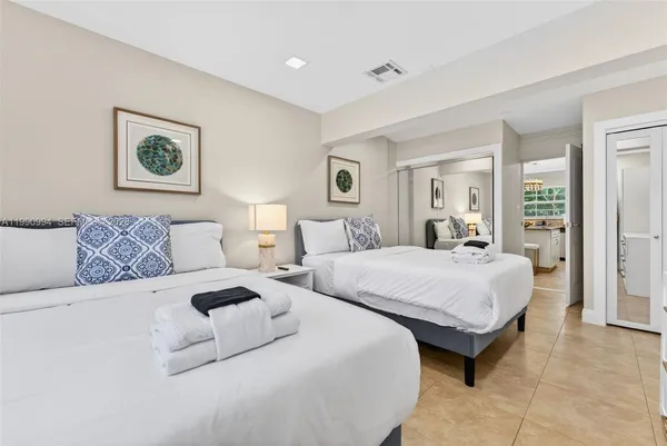 a spacious bedroom with two beds and a couch