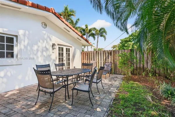 a view of a house with a table and chairs