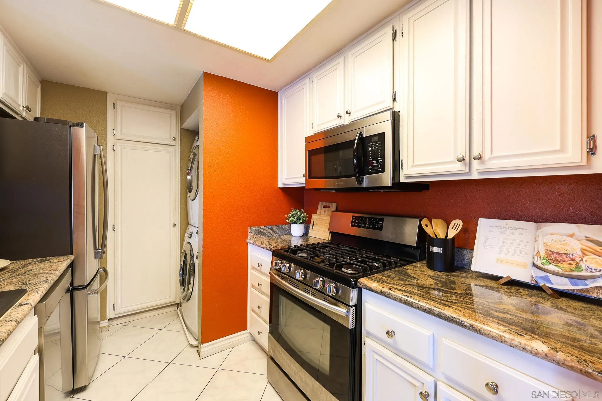 2946 Anawood Way Spring Valley, CA 91978 - Photo 21 of 45 a kitchen with stainless steel appliances granite countertop a stove a sink and a microwave