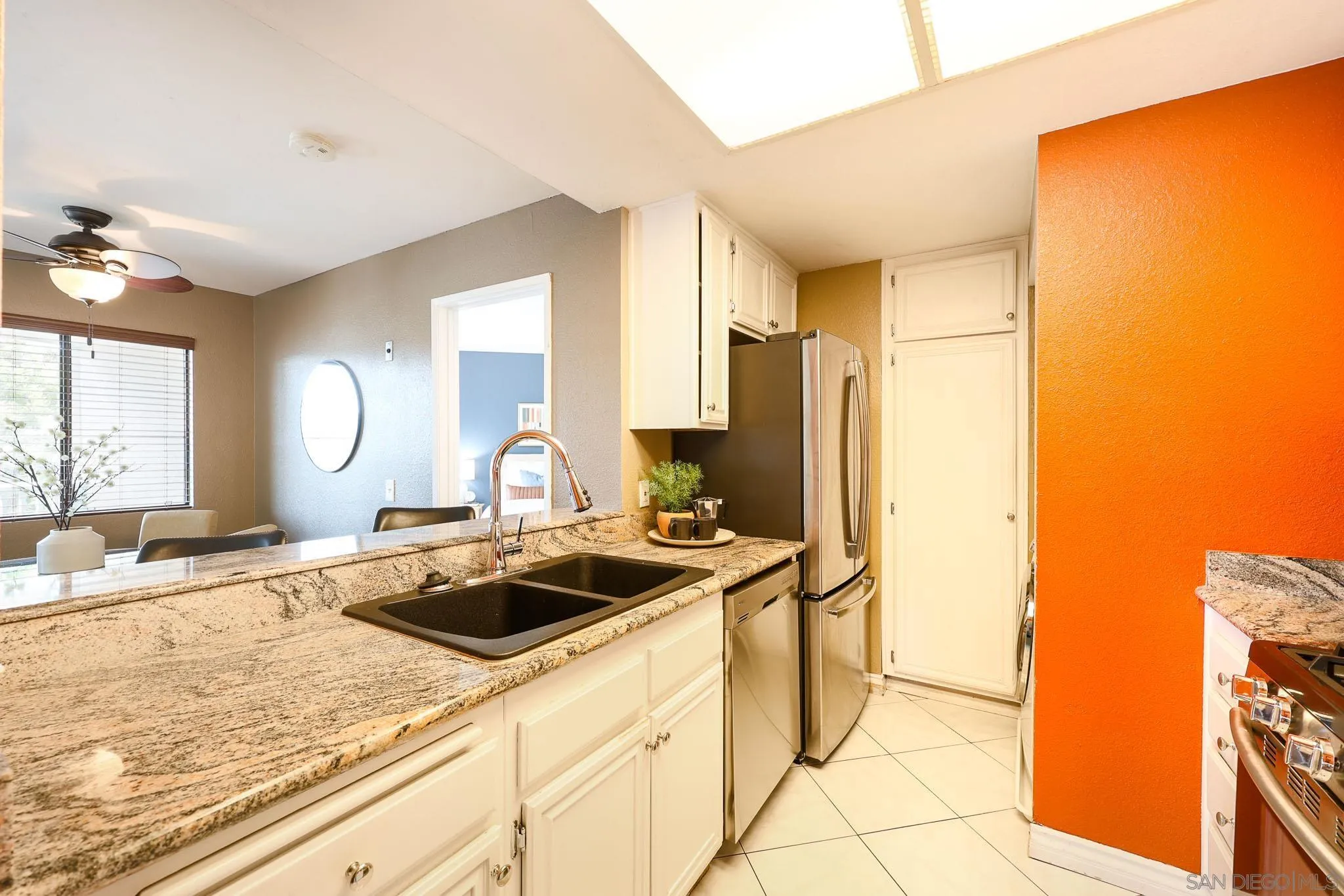 2946 Anawood Way Spring Valley, CA 91978 - Photo 23 of 45 a kitchen with stainless steel appliances granite countertop a sink a stove and a refrigerator