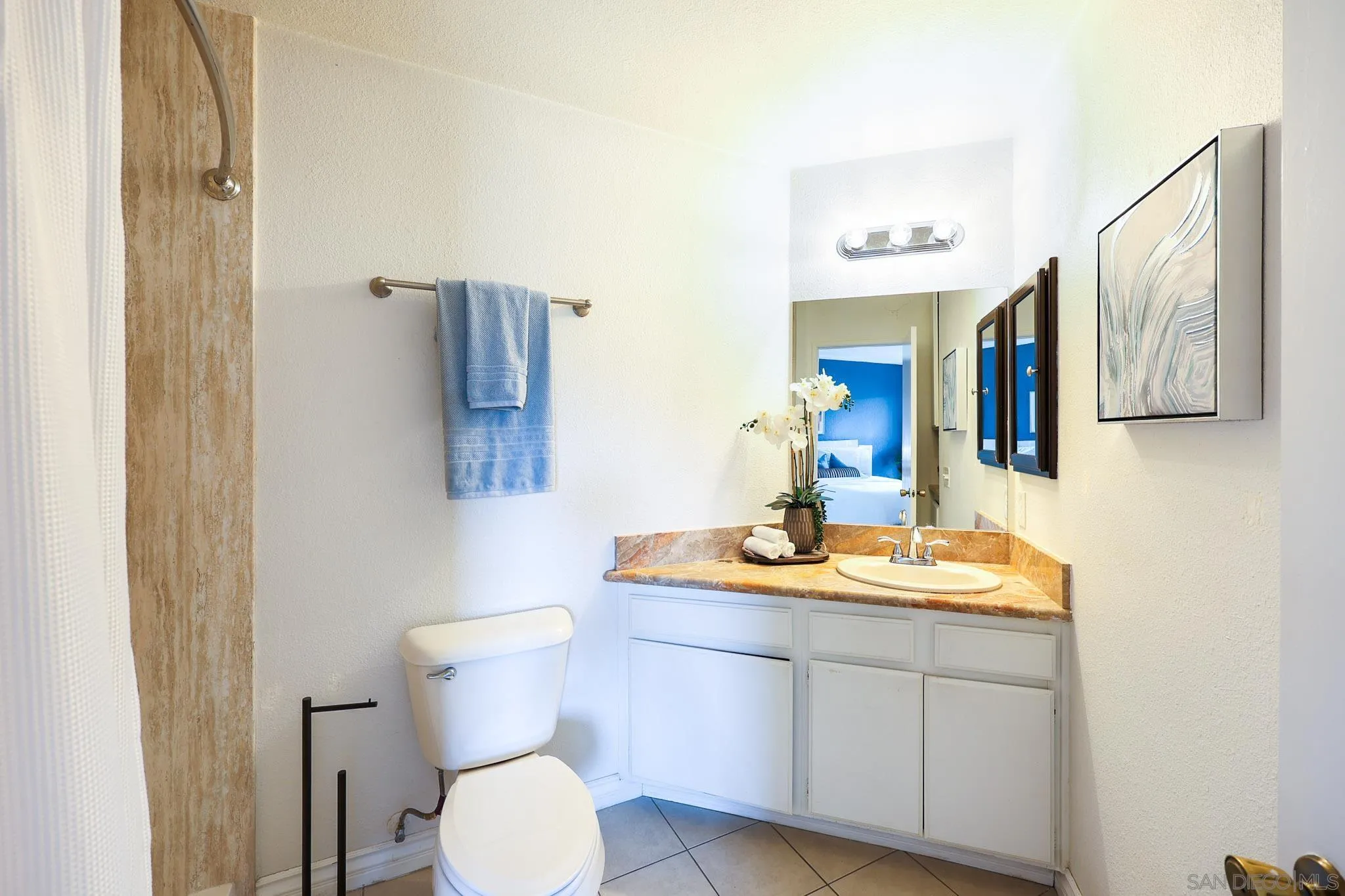2946 Anawood Way Spring Valley, CA 91978 - Photo 27 of 45 a bathroom with a toilet sink and mirror