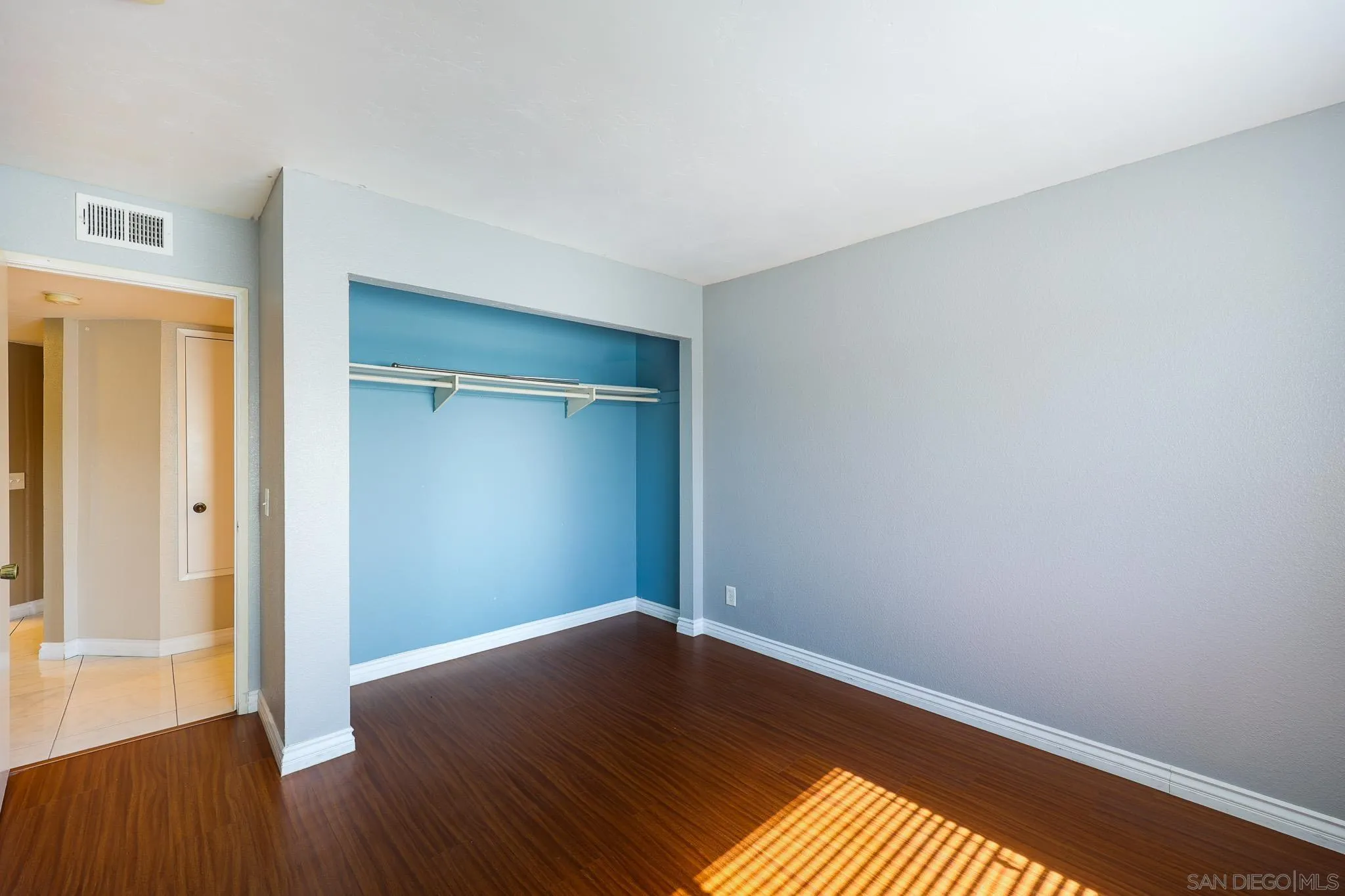 2946 Anawood Way Spring Valley, CA 91978 - Photo 32 of 45 an empty room with wooden floor and closet