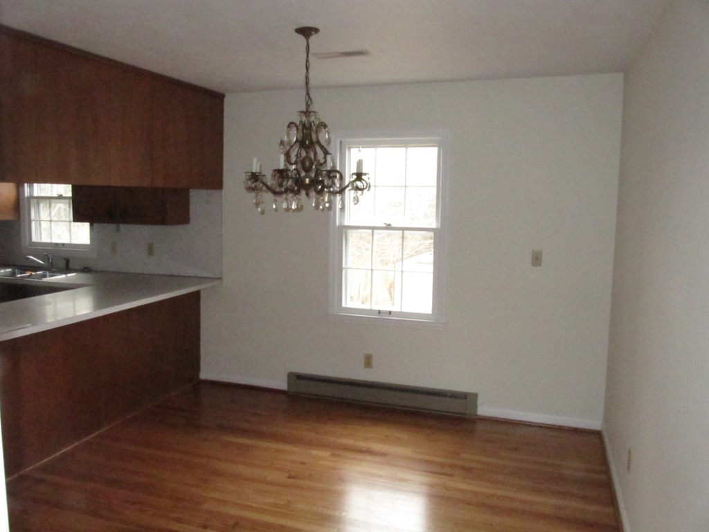 3587 Edwardsville Road Hardy, VA 24101 - Photo 3 of 12 a kitchen with granite countertop a stove and a wooden floor