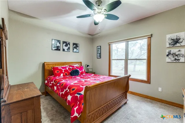 a bathroom with a granite countertop toilet a sink and a mirror