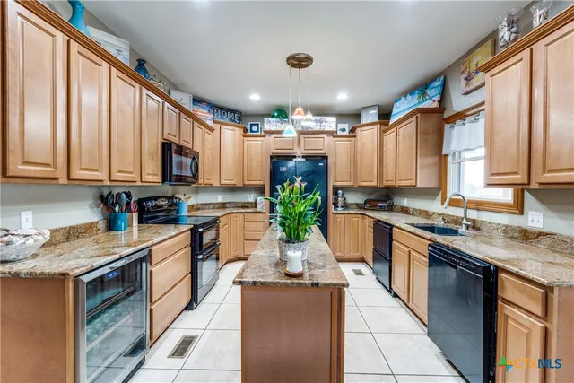 a bathroom with a granite countertop sink a mirror and a shower