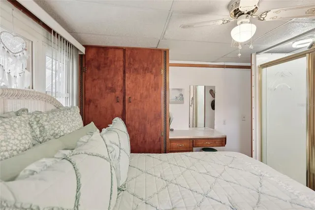 a bedroom with a large bed and a chandelier