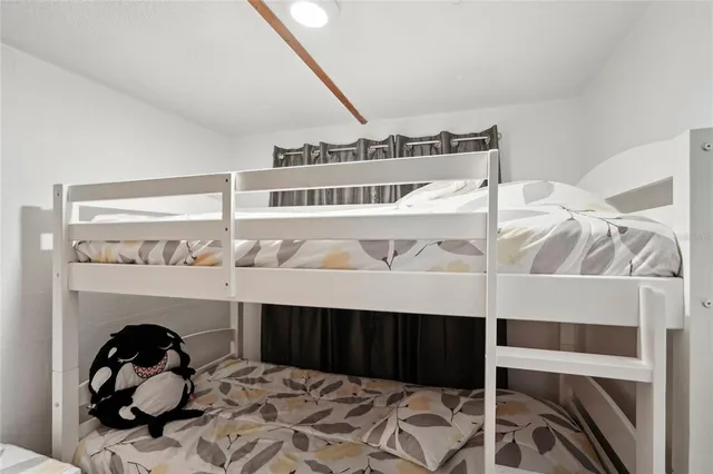 a bedroom with a bed and a fireplace