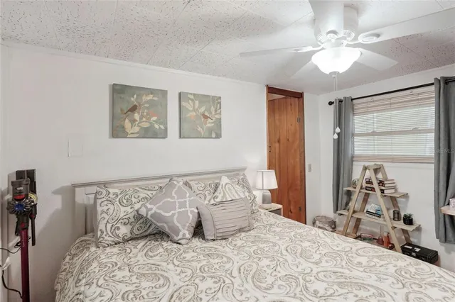 a bedroom with a large bed and a chandelier