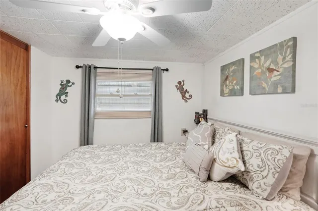 a bedroom with a large bed and a chandelier